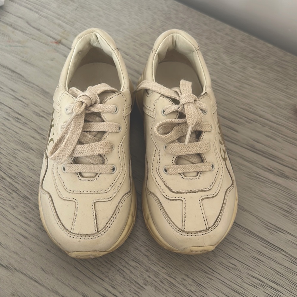 Toddler GUCCI shoes ( REAL ) worn maybe 2/3 times . The color is a beige color.